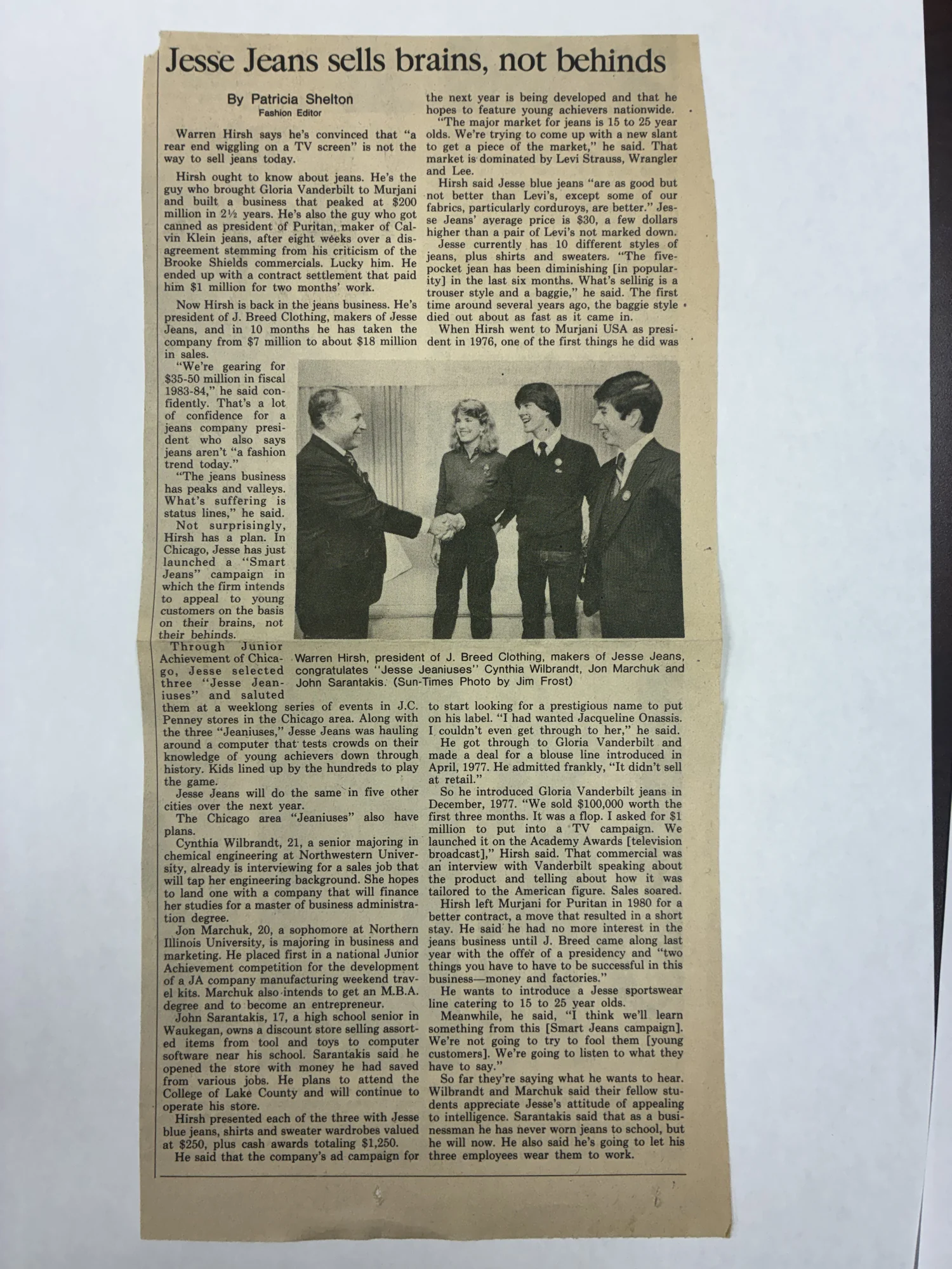 A September 1983 Sun-Times article, Jesse Jeans sells brains, not behinds, picturing John Sarantakis with two other Junior Achievement students.