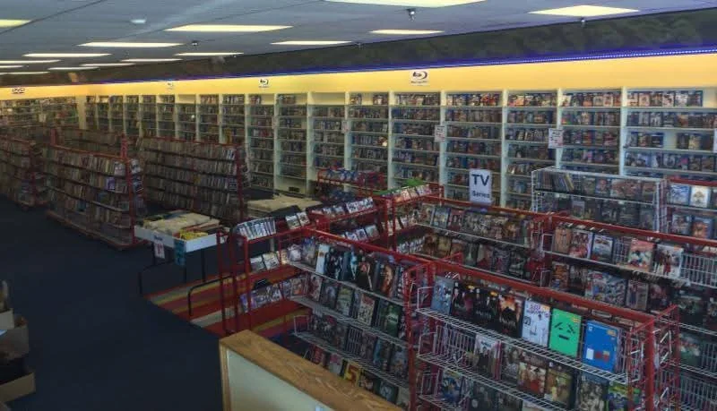 The interior of the former Blockbuster store in Waukegan filled with People’s Choice movie racks and shelves of DVDs and Blu-rays during the 2015 liquidation sale.