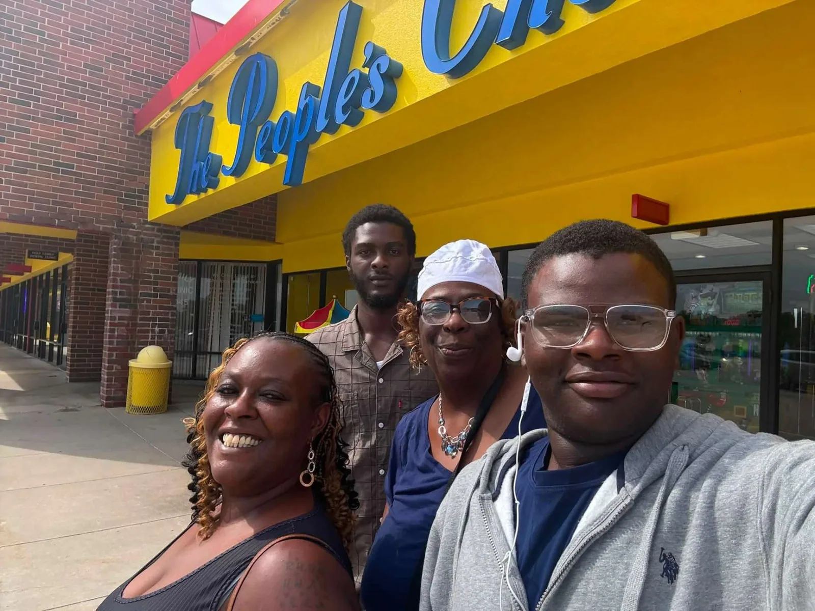 A family takes a selfie under the yellow People’s Choice marquee outside the front doors — Sharon Martin Johnson, August 21, 2026: “Having fun with the Fam.”