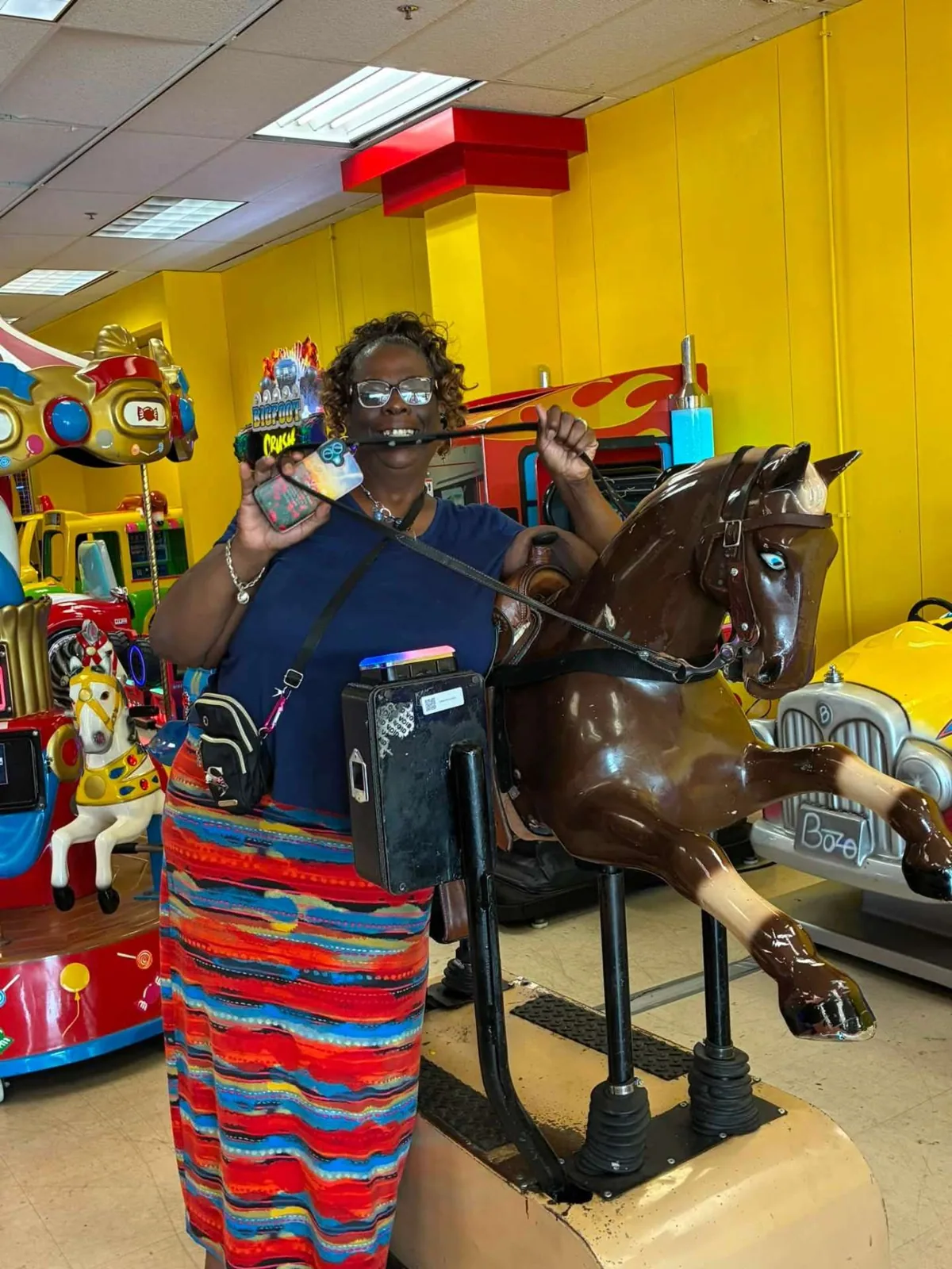 A guest laughs while holding the reins of the classic horse ride at People’s Choice — Sharon Martin Johnson, August 21, 2026.